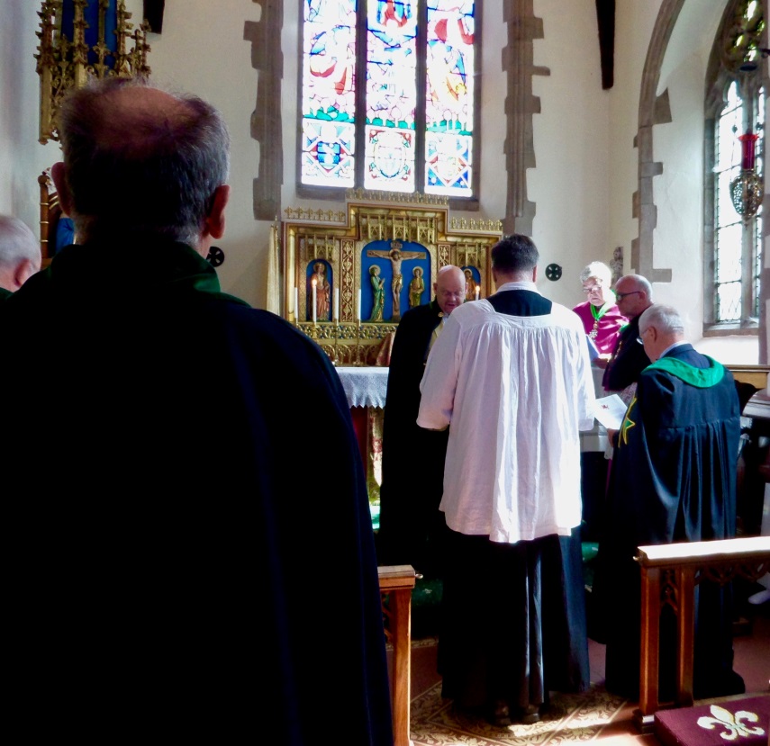 The Commander invests Fr Alexander with the insignia of a Member of the Companionate of Merit (MMLJ)